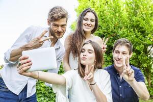 group of young friends take a selfie hugged together photo