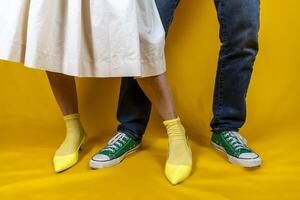 male and female legs with shoes in the style of the 50s on a colored background photo