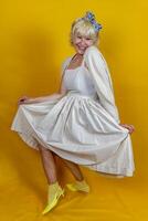 Funny portrait of mature woman. A beautiful lady is wearing a 50s style dress. photo