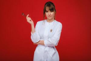 Beautiful girl doctor with a tuning fork stands photo