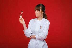 Beautiful girl doctor with a tuning fork stands photo