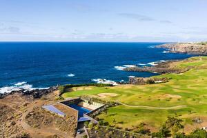 Golf course near the Atlantic ocean in Tenerife, Spain, green Golf course, tennis court in the nature of Tenerife photo