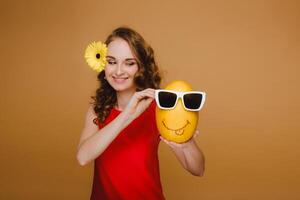 Portrait of a happy young woman holding a melon with glasses. Melon with a smile photo