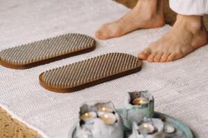 The man's feet are next to boards with nails. Yoga classes photo