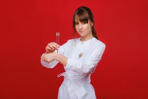Beautiful girl doctor with a tuning fork stands photo