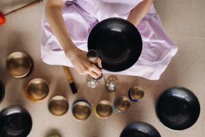 Close-up of a Tibetan singing bowl in your hands - Translation of mantras transform your impure body, speech and mind into a pure exalted body, speech and mind of a Buddha photo