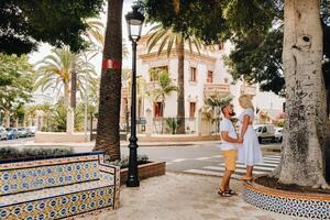 A couple in love stands in the city of Santa Cruz on the island of Tenerife, Canary Islands, Spain photo