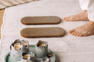 The man's feet are next to boards with nails. Yoga classes photo