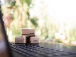 Carton boxes on a laptop keyboard. Concepts about online shopping that offers home delivery photo