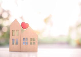 Miniature house with red heart for investment property concept. photo