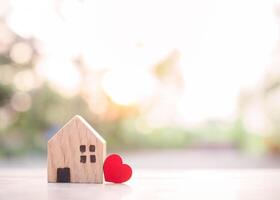 Miniature house with red heart for investment property concept. photo