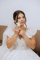 Wedding boutonniere of flowers in the hands of the bride. Wedding details. The first meeting of the bride and groom. The bride is waiting for the groom. Portrait of the bride. photo