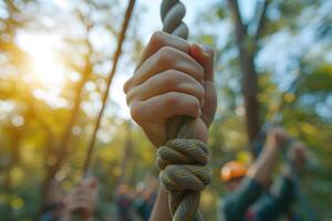 AI generated Close Up of Hands Holding Rope with blurry Outbound Team Building Activity Background photo