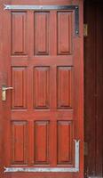 Texture of red entrance door to residential building photo