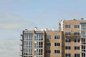 View of a large construction site with buildings under construction and multi-storey residential homes. Housing renovation photo