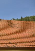 The roof of this square ceramic tile is red. The old type of roof covering in rich houses of the 19th century photo