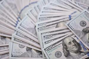 Very big amount of US hundred dollar bills. Huge quantity of united states currency notes on flat table photo