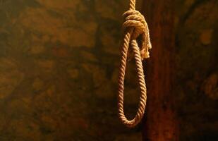 Noose in prison of old castle cellar and grunge stone wall photo