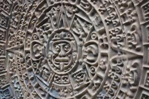 Ancient Mayan Calendar or Aztec calendar with rough relief surface photo