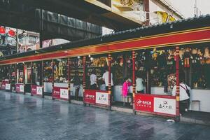 Yunan, China, 2016 - People in an ancient Chinese town walking in front of the doll store photo