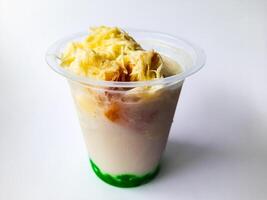 Durian Cendol Ice Drink topped with grated cheese and slices of bread photo