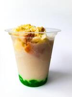 Durian Cendol Ice Drink topped with grated cheese and slices of bread photo