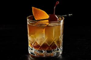 AI generated Alcoholic old fashioned cocktail with orange slice, cherry and orange peel garnish photo