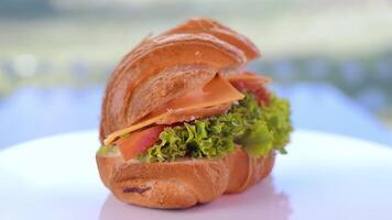 croissant pour petit déjeuner. croissant remplissage avec légumes verts et jambon. fermer de une croissant tournant sur une 360 Plate-forme video