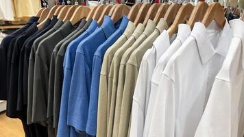 Various color shirts at shelf in shop. Bekasi, Indonesia, March 14, 2024 photo