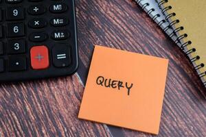 Concept of Query write on sticky notes isolated on Wooden Table. photo