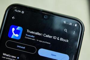 True Caller application on Smartphone screen. Caller ID and Block is a freeware web browser developed by True Caller. Bekasi, Indonesia, March 2, 2024 photo