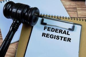 Concept of Federal Register write on paperwork isolated on wooden background. photo