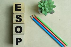 Concept of The wooden Cubes with the word ESOP on wooden background. photo