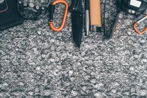 Flat lay of some Outdoor EDC gear on a grey background. photo