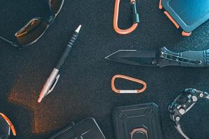 Flat lay of some Outdoor EDC gear on a dark background. photo