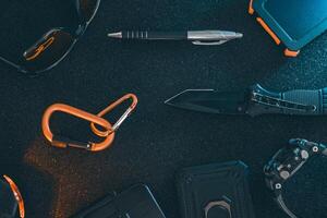 Flat lay of some Outdoor EDC gear on a dark background. photo