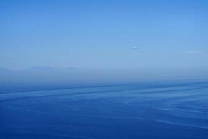 a plane in the immensity of the sky photo