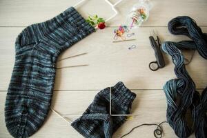 Set for hand knitting warm winter socks made of natural woolen yarn. photo