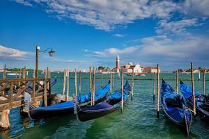 Gondolas and in lagoon of Venice by San Marco square. Venice, Italy photo