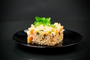 Cooked boiled rice with zucchini, carrots and vegetables in a plate photo