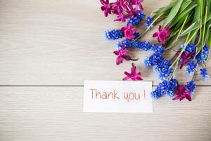 beautiful bouquet of spring flowers on a wooden table photo