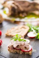 sandwich with baked meat, radish and herbs photo