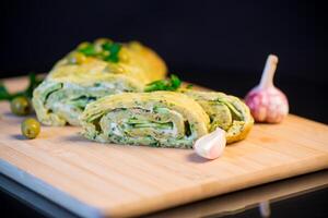 vegetable zucchini roll with garlic cheese filling inside. photo