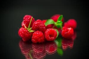 Sweet raspberry fruit isolated on black background photo