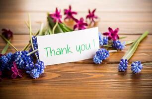 beautiful bouquet of spring flowers on a wooden table photo