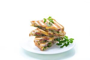 fried toasts stuffed with sausage, cheese and greens inside, on white background. photo