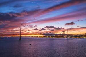 View of 25 de Abril Bridge at evening. Lisbon, Portugal photo