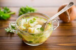 cooked chicken soup with cauliflower and vegetables in a bowl photo