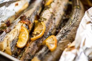 Baked fish with seasonings and spices in foil photo