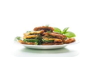 zucchini fried in circles in batter with herbs, in a plate. photo